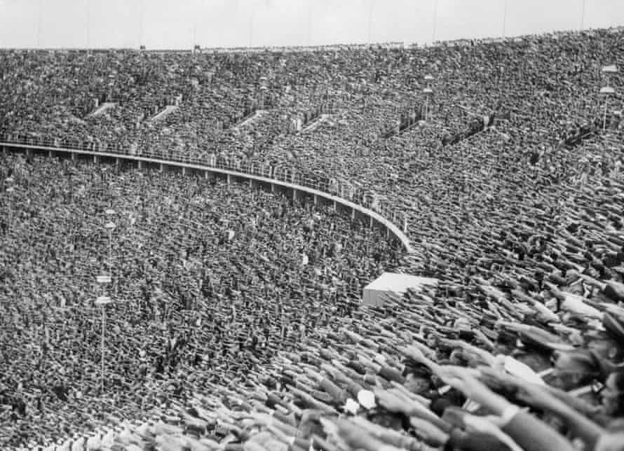 The crowd at the 1936 Olympic Games in Berlin raise their hands in the Nazi salute in tribute to Hitler's arrival at the stadium.