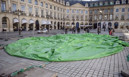 The deflated sculpture in Place Vendôme after vandals cut the cables holding it up.
