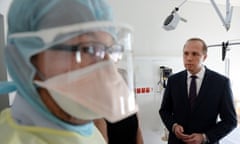 Peter Dutton with a nurse in protective gear during a visit to the Royal Brisbane hospital in Brisbane. Photograph: Dan Peled/AAP