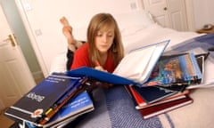 Girl on bed with revision books