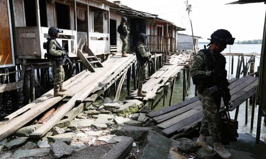 Colombian navy special forces on patrol among stilted waterfront shacks in Buenaventura