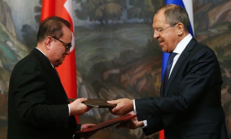 Russian Foreign Minister Sergei Lavrov (right) and his North Korean counterpart Ri Su-yong exchange documents in Moscow this week.