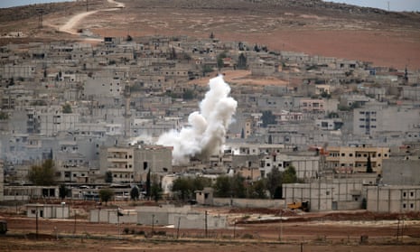 Smoke rises following a strike in Kobani, Syria, during fighting between Syrian Kurds and Islamic State militants.