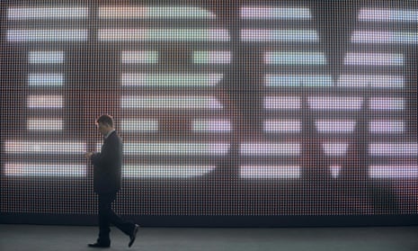 A man walks past the IBM logo at a technology conference
