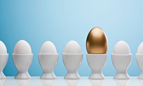 Golden egg in an egg cup with others around