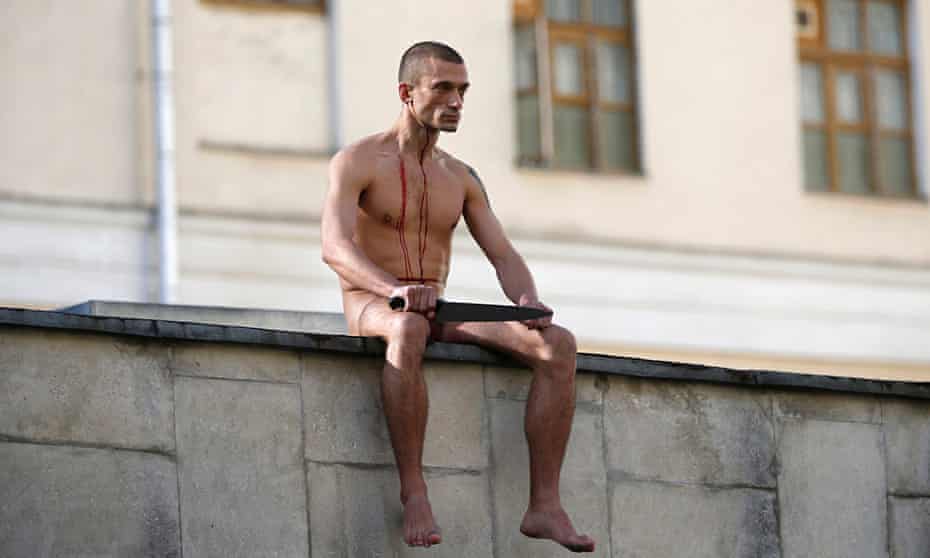 Pyotr Pavlensky on the wall of the Serbsky psychiatry   centre after he sliced off part of his earlo