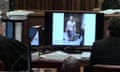 An image from the court showing on screen a police photograph of Oscar Pistorius standing on his blood-stained prosthetic legs.