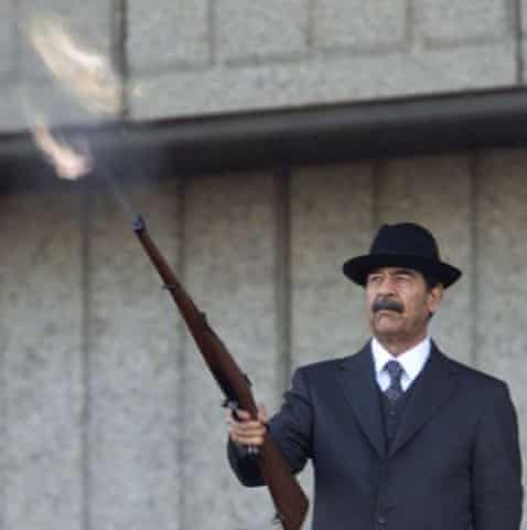 Saddam Hussein fires a rifle