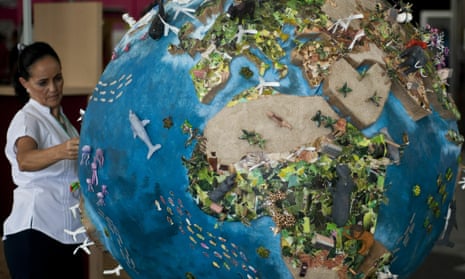 A woman looks at a globe model in the climate village during the United Nations Framework Convention on Climate Change (COP-16), in Cancun, 2010.