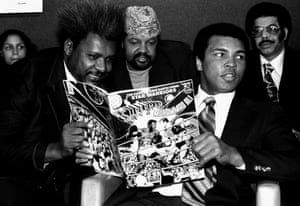 The world heavyweight champion is pictured with promoter Don King holding a comic book in which Ali is shown beating Superman.