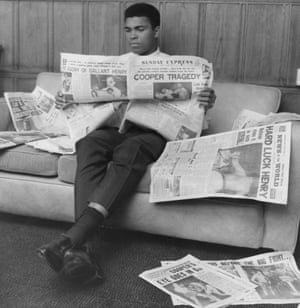 Ali reads the Sunday Express newspaper after demolishing Henry Cooper in their second fight in 1966.