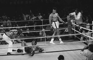 Referee Zack Clayton counts out Foreman in round eight of the title bout, after Ali’s ‘rope-a-dope’ tactics had worn the young champion out.