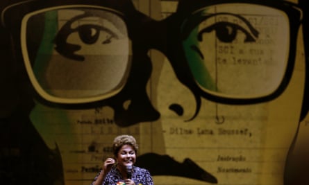 Dilma Rousseff speaking at a rally before a picture of her as a Marxist student activist, when she was tortured by the military dictatorship.