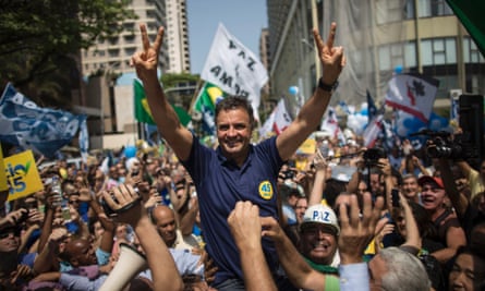 Aécio Neves greets supporters while campaigning at Copacabana beach in Rio de Janeiro.