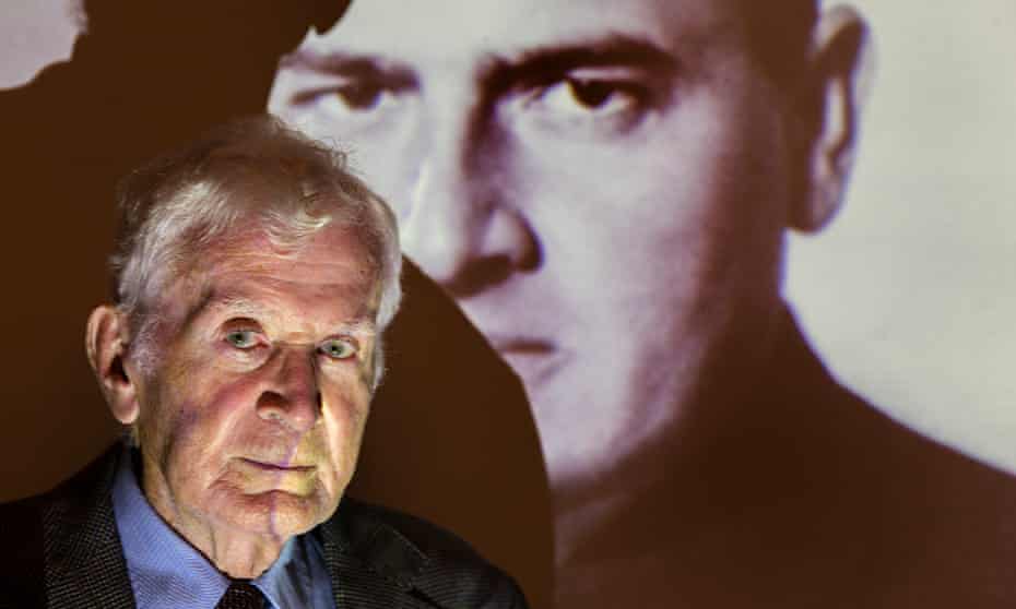 Siegfried Ramler in front of a projection of Hans Frank, the 'Butcher of Warsaw'. 