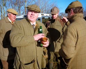 Men enjoy a nip of sloe gin during a pheasant shoot in the Wiltshire. December, 2001.