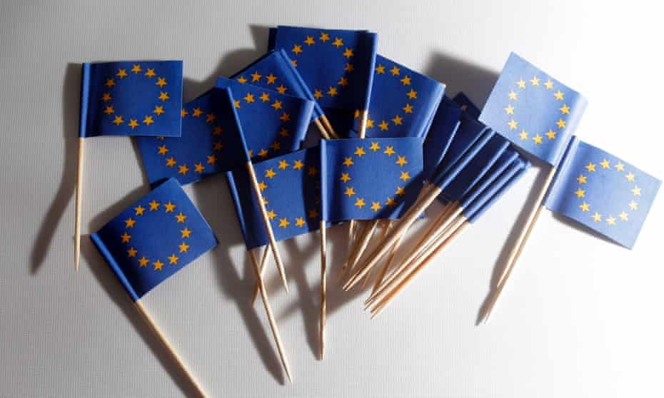 EU flags on toothpicks lie on a table during a photo opp at a flag store in Vienna, Austria.