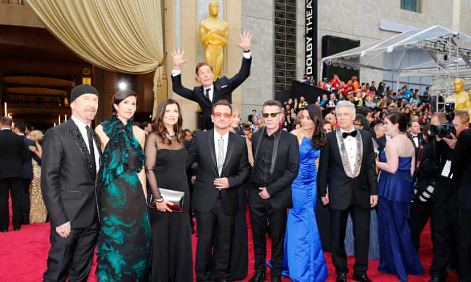 Actor Benedict Cumberbatch jumps behind U2 at the 86th Academy Awards in Hollywood