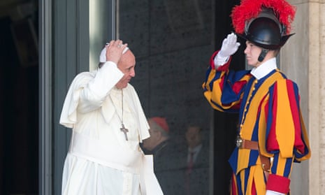 A Swiss Guard salutes Pope Francis at the Vatican