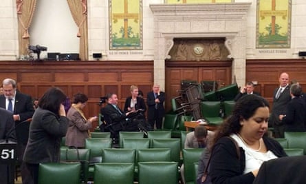 In this photo provided by Conservative MP Nina Grewal, members of Parliament barricade themselves in a meeting room on Parliament Hill in Ottawa.