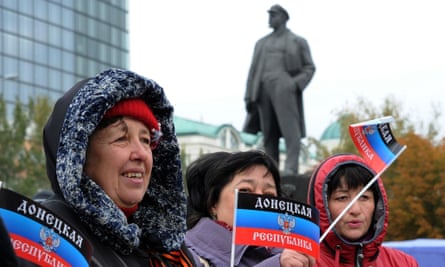Women wave the separatist Donetsk People's Republic's flag at its presentation on Lenin square in Donetsk in eastern Ukraine last week.