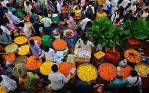 Mumbai, India A crowded market selling marigold flowers early this morning. Marigold flowers are popularly used as offerings and for rituals and decorations
