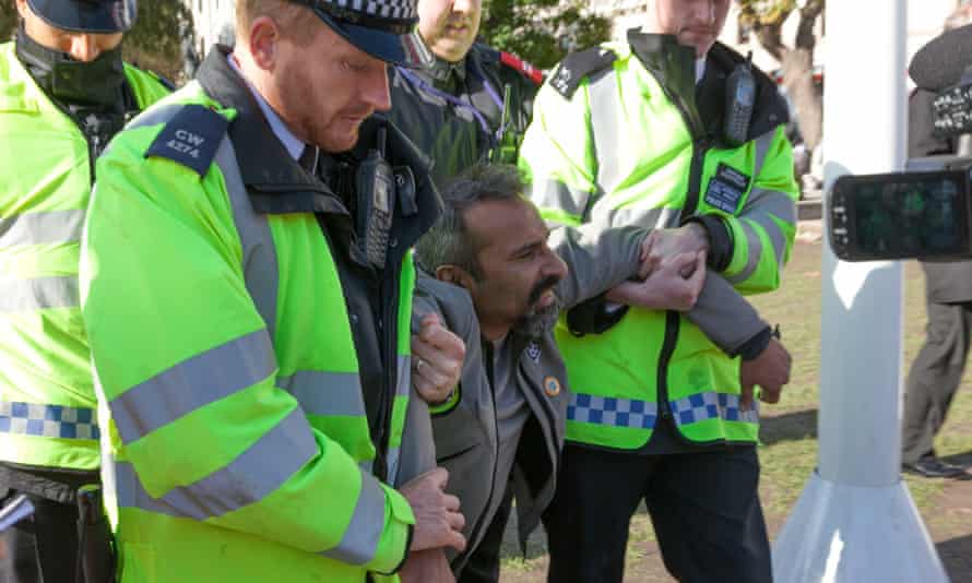Police remove a protester from Parliament Square