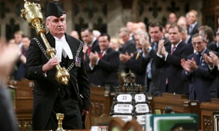 Sergeant-at-Arms Kevin Vickers is applauded in the House of Commons in Ottawa. Vickers is credited with shooting the gunman in parliament.