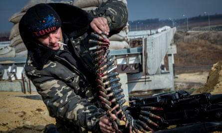 A soldier of the Ukrainian volunteer battalion Dnepr-1 loads a machine gun at a checkpoint near Donetsk airport.