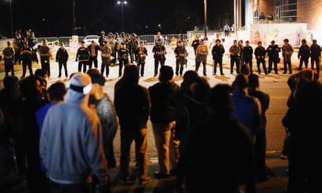 Police face off with demonstrators outside a police station in protests following the shooting of Michael Brown.
