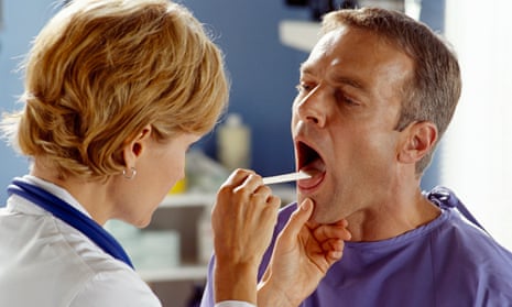 Doctor examining patient's throat