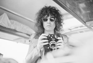 Singer Marc Bolan (1947 - 1977), of English glam rock group T-Rex, holding a Nikon camera on a tour bus during a four-date British tour, June 1972. (Photo by Michael Putland/Getty Images)