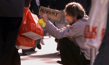 Holiday shoppers walk past Mick Smith, one of San Francisco's homeless