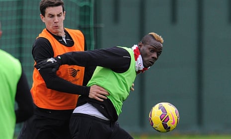 Liverpool's Mario Balotelli tries to fend off Jordan Williams during training