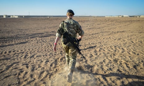 A British officer walks on deserted ground inside Camp Bastion on the exact spot where the very first tents were erected in 2006.