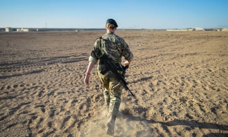 A British officer walking on deserted ground inside Camp Bastion, Helmand province, Afghanistan, on the exact spot where the very first tents were erected in 2006.