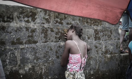 The daughter of an Ebola victim grieves in Monrovia, Liberia.