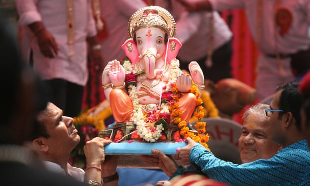 Ganesh is carried by devotees in a religious procession in New Delhi
