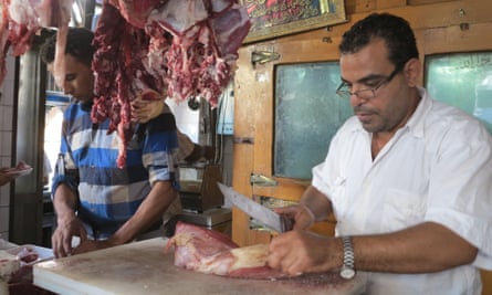 Butcher Boulboul Hassan gets to work on a carcass at his shop in Cairo.