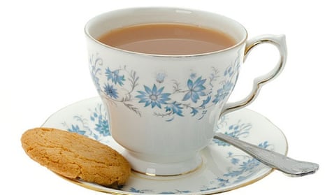 Classic cup of tea on saucer with biscuit