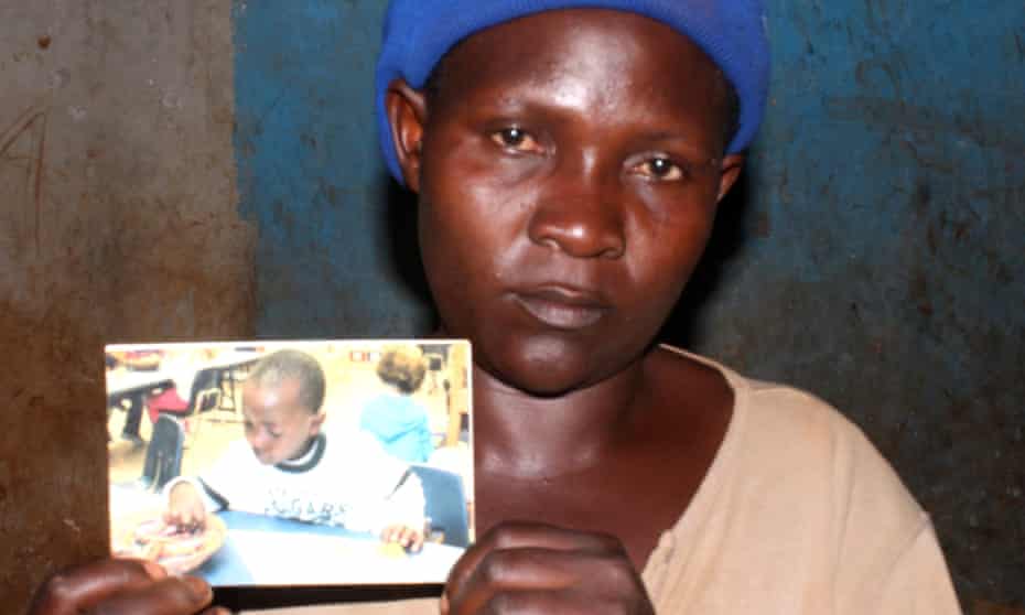 Nakiwala Hasifa with a picture she says is of her son, who is now in the US.