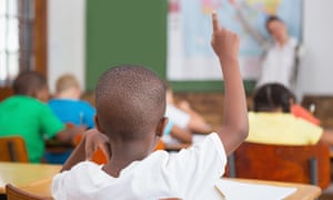 Pupil raising hand in classroom