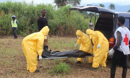 Health workers carry the body of an Ebola virus victim in the Waterloo district of Freetown.