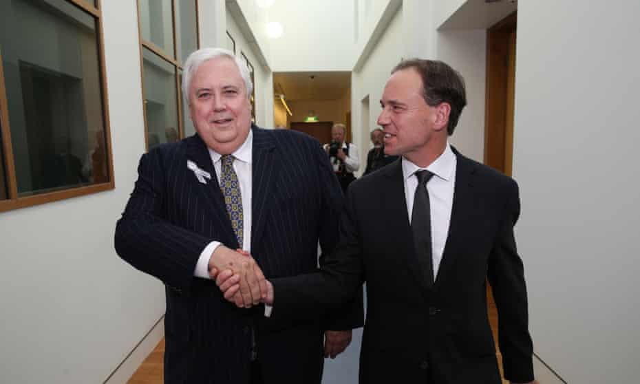 Palmer United Party leader and coal miner Clive Palmer shakes the hand of Environment Minister Greg Hunt after striking a deal to pass the Government's Direct Action policy through Australia's Senate.