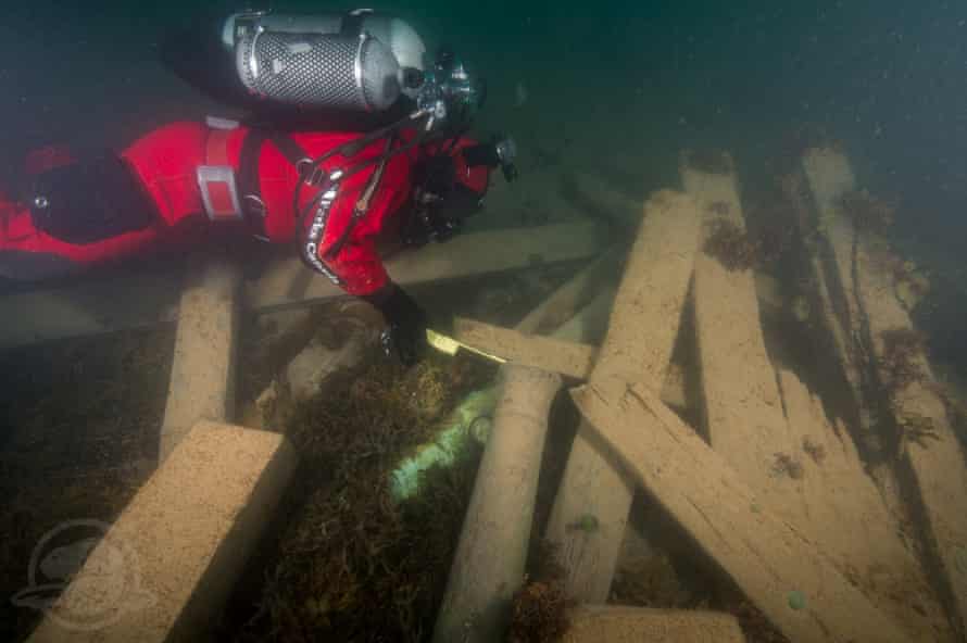 Filippo Ronca explores cannon and timbers from the wreck of the Erebus.