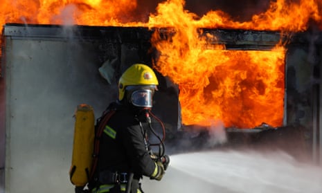 Firefighter outside a burning building