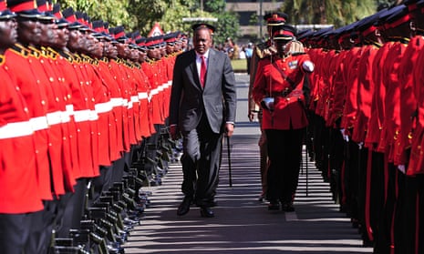 Uhuru Kenyatta reviewing troops before addressing parliament in Nairobi, when he said he would go to