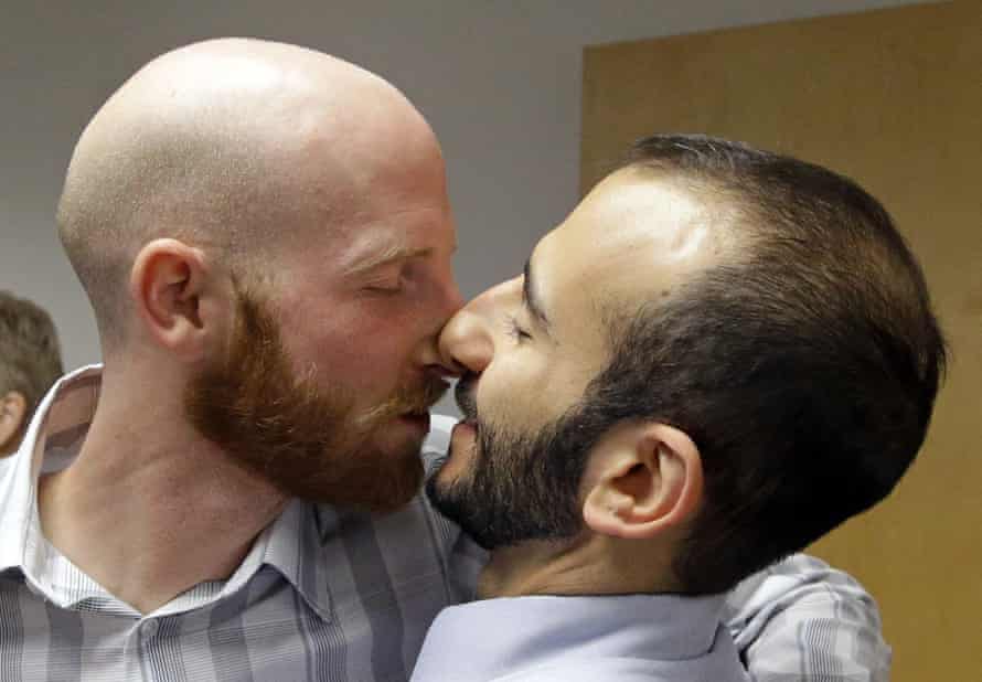 Plaintiffs Moudi Sbeity, right, and his partner Derek Kitchen, one of three couples who brought the lawsuit against Utah's gay marriage ban, kiss following a news conference Monday, Oct. 6, 2014, in Salt Lake City.