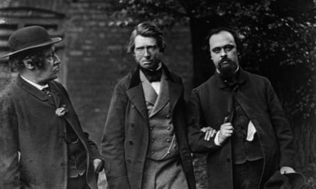 Dante Gabriel Rossetti, right, arm in arm with John Ruskin as William Bell Scott looks at them.