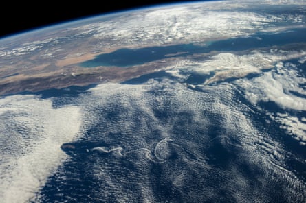 Although land and waters of Mexico's Pacific area pictured here are influenced by masses of clouds, for Baja California and other parts of Mexico in this photograph made from the International Space Station, things are quite calmer than a few days ago when Hurricane Odile unleashed.